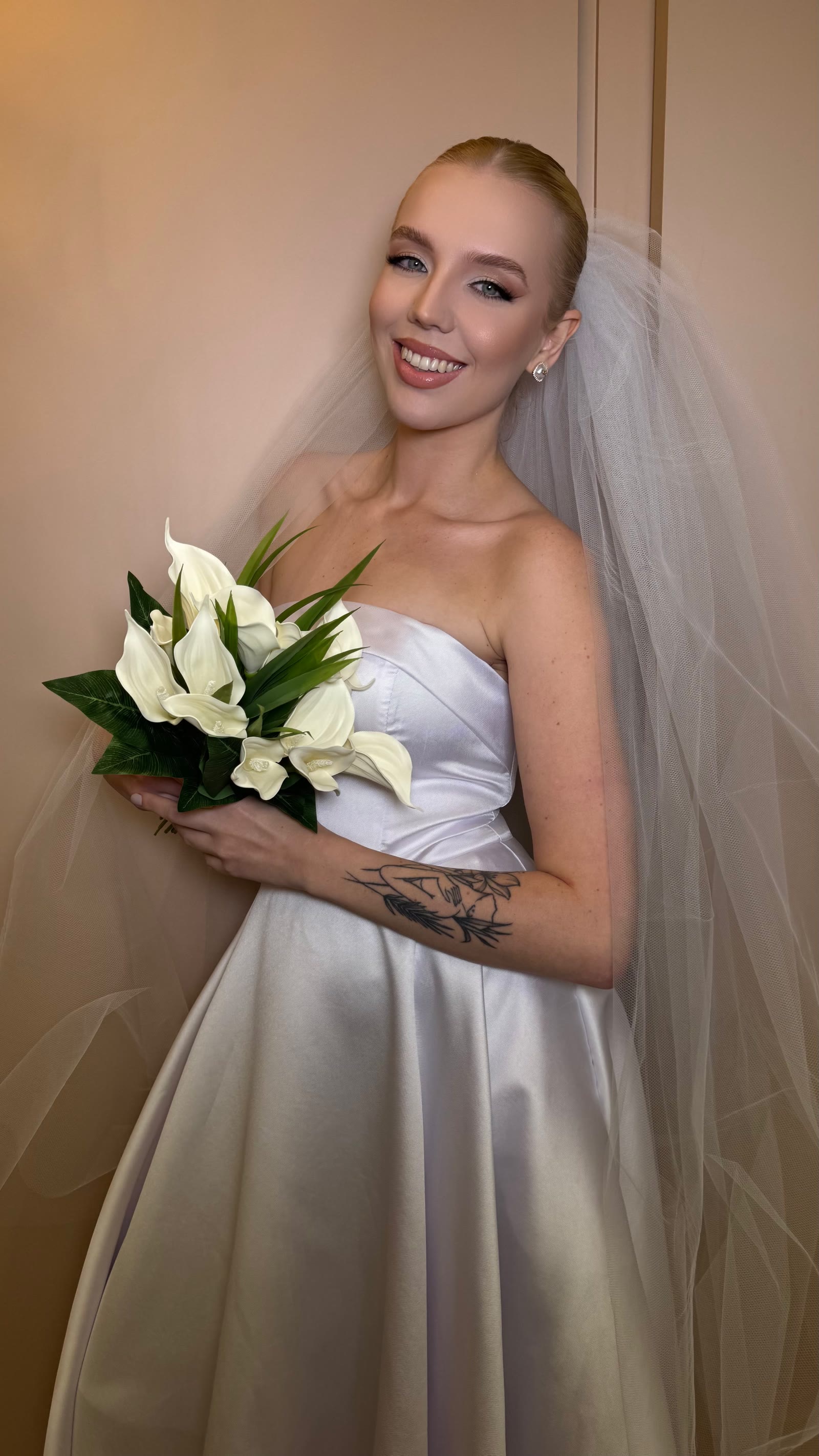 Halana Salvadori com vestido de noiva e buquê de flores brancas